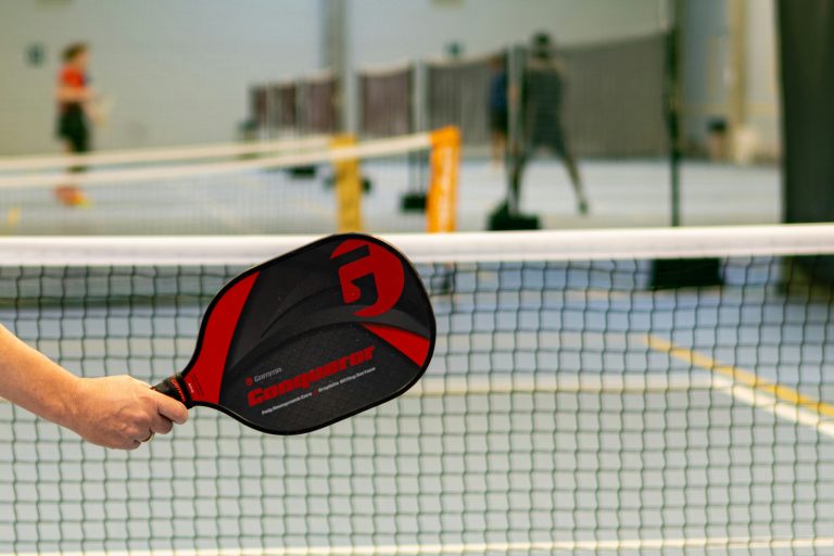 pickleball player showcasing the best pickleball paddle on an indoor court