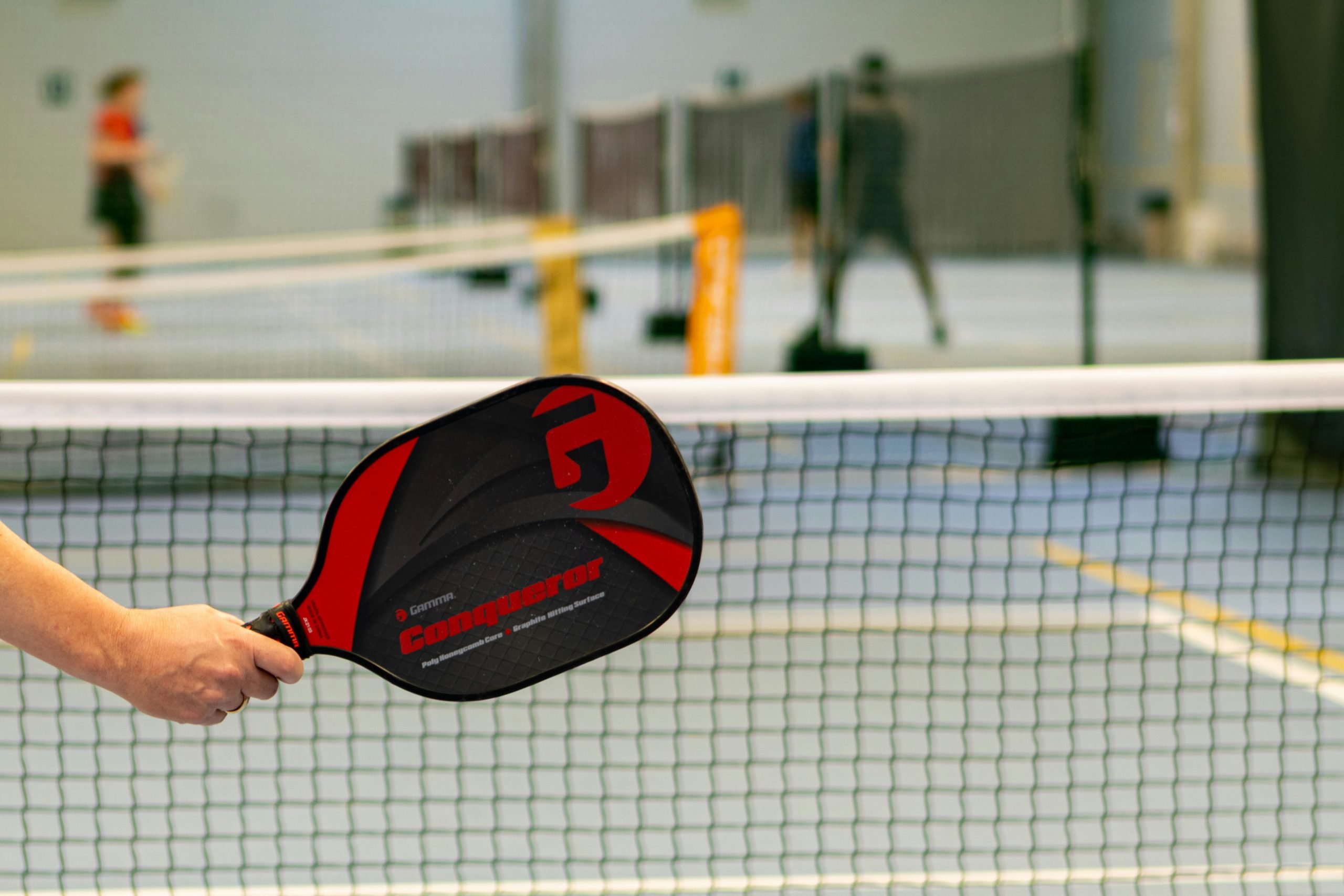 pickleball player showcasing the best pickleball paddle on an indoor court