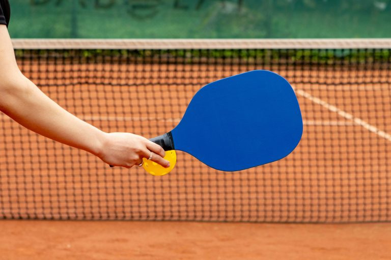a women holding a pickleball preparing to show what makes a good pickleball paddle