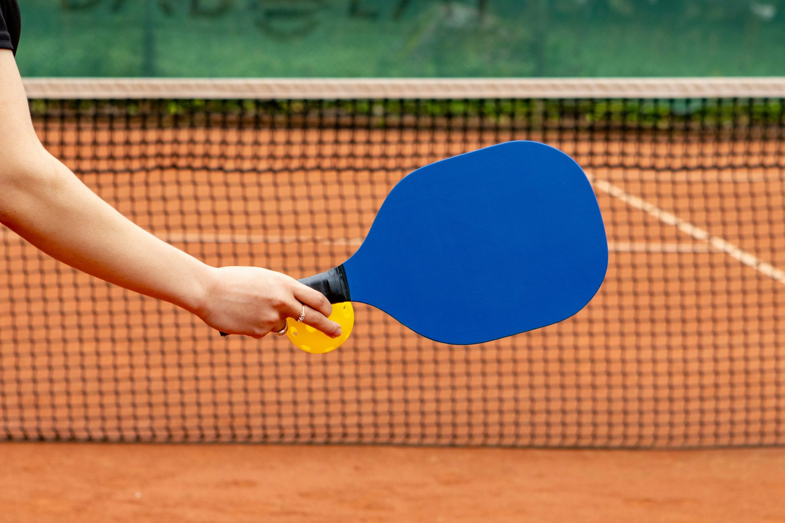 a women holding a pickleball preparing to show what makes a good pickleball paddle